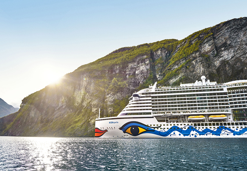 AIDAperla im Fjord AIDAperla auf dem Wasser vor Fjordlandschaft