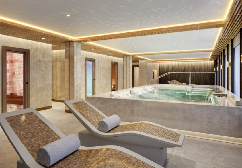 Serene Spa & Wellness auf der Seven Seas Prestige Der Serene Spa & Wellness Bereich der Seven Seas Prestige mit einem großen Hydrotherapie-Pool und mehreren beheizten Ruheliegen. Der helle Wellnessbereich ist in warmen Beige- und Brauntönen gestaltet.
