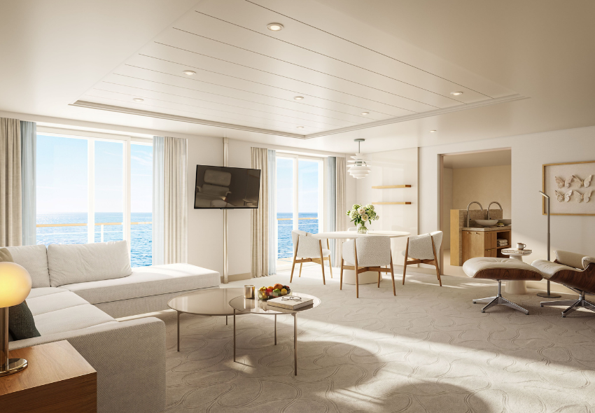 Blick in eine modernisierte Suite im hellen Design mit Balkon an Bord der EUROPA 2